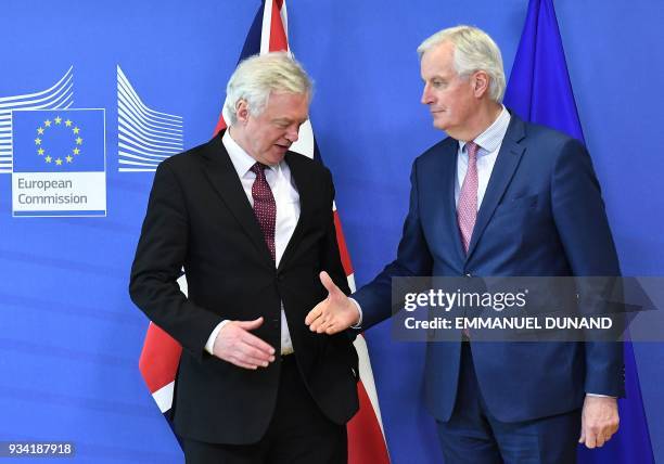 British Brexit minister David Davis and EU chief negotiator Michel Barnier prepare to shake hands as they meet at the European Commission in Brussels...