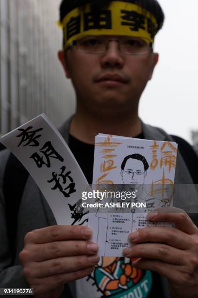 Protester holds a drawing of Taiwanese activist Lee Ming-che during a demonstration in Taipei on March 19, 2018. Taiwanese human rights activist Lee...