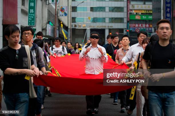 Activists march during the Commemorating Lee Ming-Ches One Year Of Imprisonment Protest in Taipei on March 19, 2018. Taiwanese human rights activist...