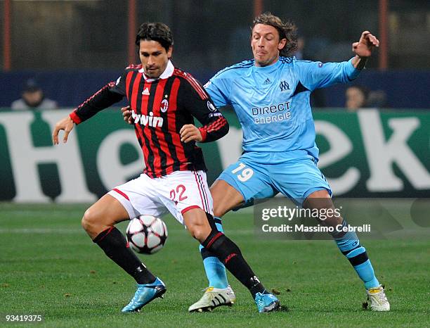 Marco Borriello of AC Milan battles for the ball with Gabriel Heinze of Olympique de Marseille during the UEFA Champions League Group C match between...