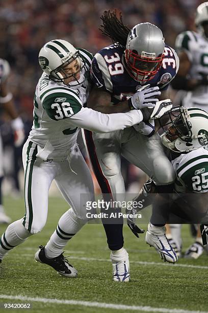 Running Back Laurence Maroney of the New England Patriots is stopped by Safety Jim Leonhard and Safety Kerry Rhodes of the New York Jets when the New...