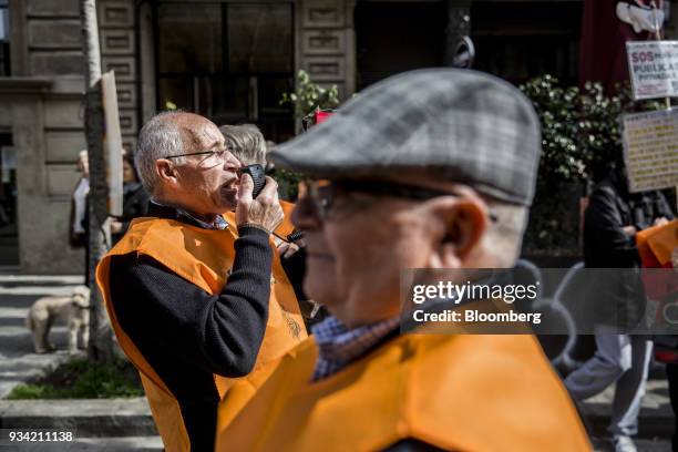 Protester speaks to fellow marchers through a megaphone during the 'Marea Pensionista' demonstration for pension reform in Barcelona, Spain, on...