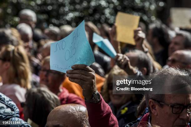 Protesters wave signs on Roger de Lluria street during the 'Marea Pensionista' demonstration for pension reform in Barcelona, Spain, on Saturday,...