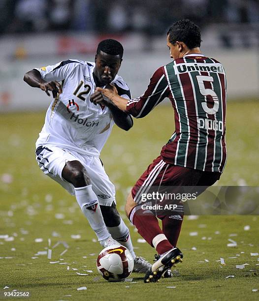 Brazilian Fluminense's Diogo vies for the ball with Ecuadorean Liga Deportiva Universitaria de Quito's Edison Mendez during their Copa Sudamericana...