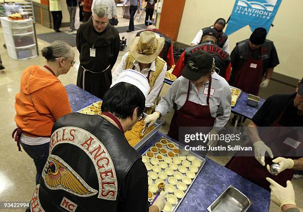 Member of the Hells Angels motorcycle club helps make miniature pumpkin pies at the St. Anthony Foundation dining room November 25, 2009 in San...