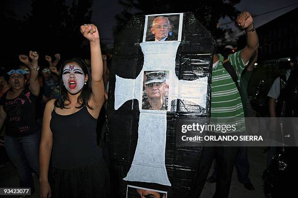 Honduran University students show a coffin with the pictures of Honduran de facto leader Roberto Micheletti , and Armed Forces Chief, general Romeo...