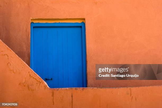 blue door and orange wall - sidi ifni stock pictures, royalty-free photos & images