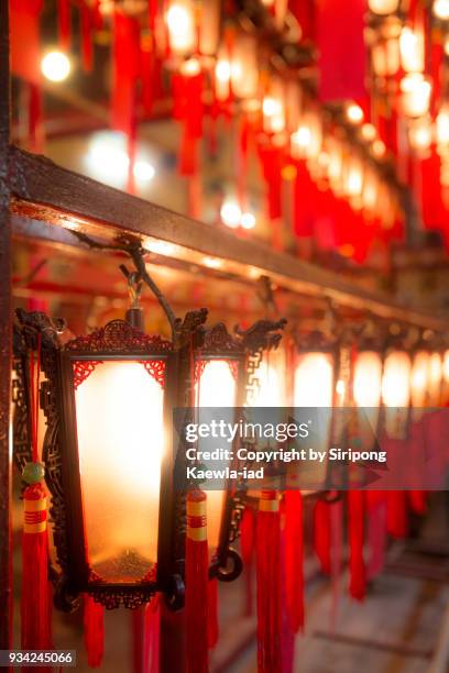 the chinese style lanterns in a line at man mo temple, hong kong. - copyright by siripong kaewla iad stock pictures, royalty-free photos & images