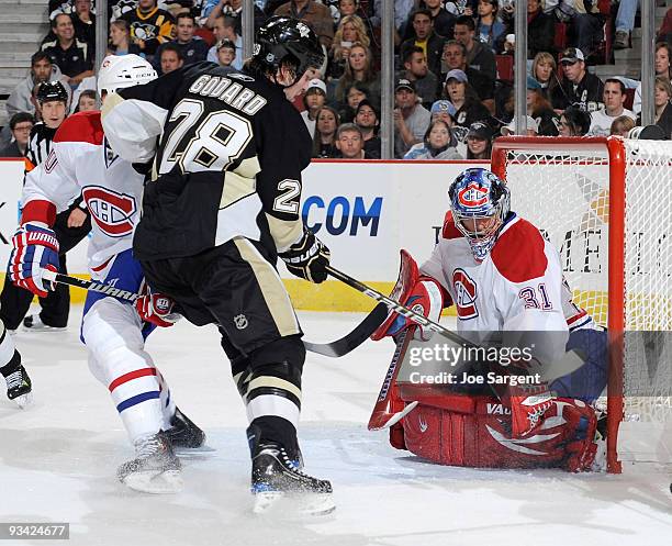 Eric Godard of the Pittsburgh Penguins has his shot blocked by Carey Price of the Montreal Canadiens on November 25, 2009 at Mellon Arena in...