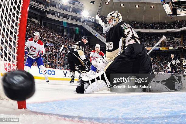 Goaltender Marc-Andre Fleury of the Pittsburgh Penguins looks back as a shot by Max Pacioretty of the Montreal Canadiens goes in the net for the...
