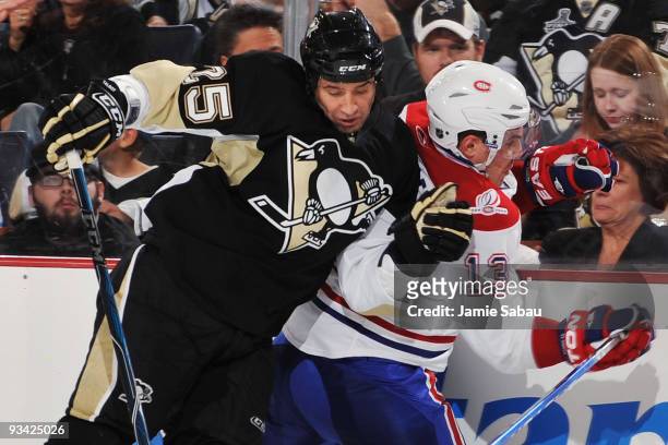 Maxime Talbot of the Pittsburgh Penguins finishes a check on Michael Cammalleri of the Montreal Canadiens on November 25, 2009 at Mellon Arena in...