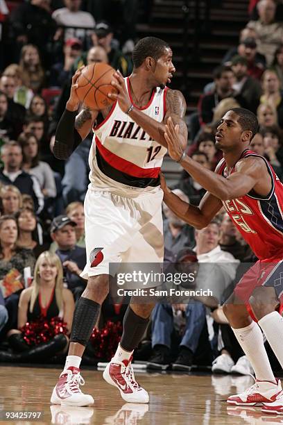 LaMarcus Aldridge of the Portland Trail Blazers looks for an opening around Sean Williams of the New Jersey Nets during a game on November 25, 2009...