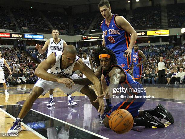 Ime Udoka of the Sacramento Kings fights for the ball with Jordan Hill of the New York Knicks on November 25, 2009 at ARCO Arena in Sacramento,...