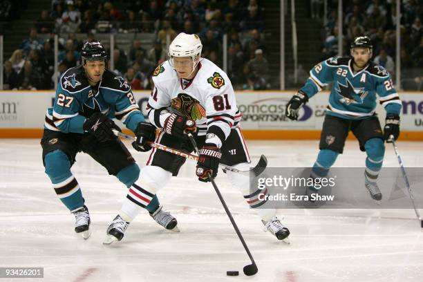 Manny Malhota of the San Jose Sharks and Marian Hossa of the Chicago Blackhawks go for the puck during their game at HP Pavilion on November 25, 2009...