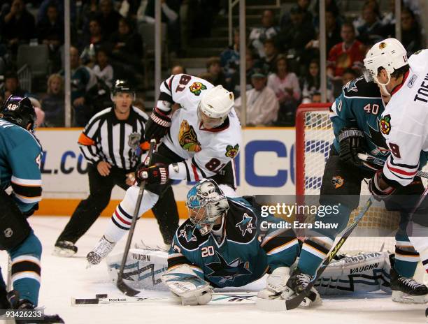 Marian Hossa of the Chicago Blackhawks is stopped by goalie Evgeni Nabokov of the San Jose Sharks during their game at HP Pavilion on November 25,...