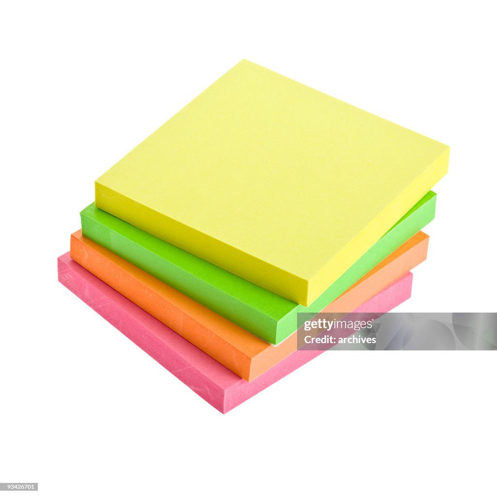 A stack of four sticky note pads in different colors