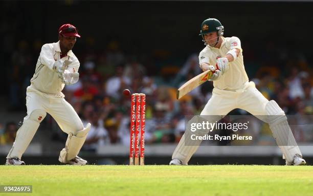 Michael Clarke of Australia cuts the ball as Denesh Ramdin of the West Indies keeps wicket during day one of the First Test match between Australia...