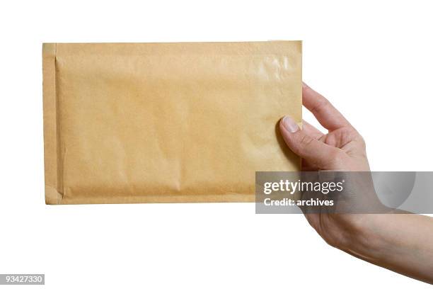 brown envelope - manila envelope hand stock pictures, royalty-free photos & images