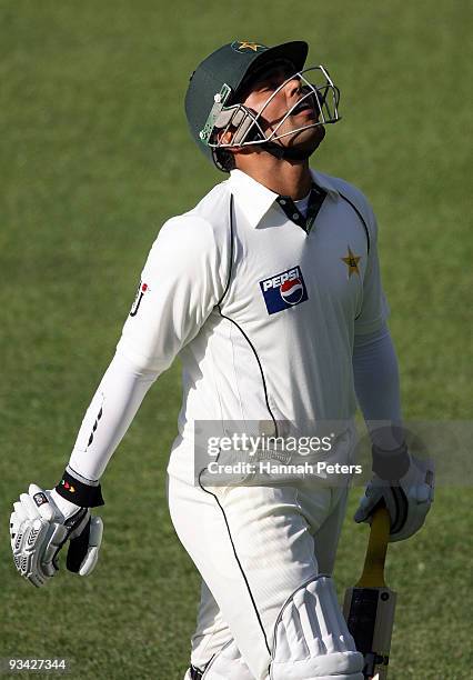 Kamran Akmal of Pakistan walks off after being dismissed for 82 runs during day three of the First Test match between New Zealand and Pakistan at...