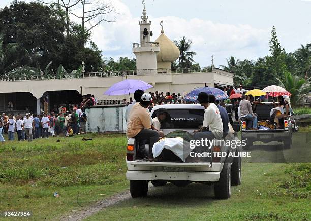 The funeral convoy of massacred Mangudadatu clan victims arrives at the family cemetery in Buluan, in the southern Philippine province of Maguindanao...