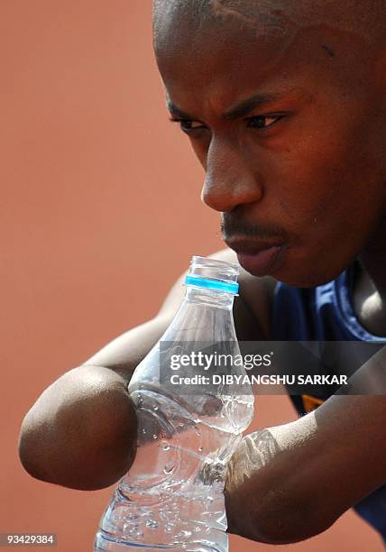 Physically challenged South African athlete Samkelo Radebe takes a break as he participates in the high jump event at the Sree Kanteerava Stadium in...