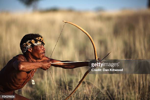 Bushman from the Khomani San community strikes a traditional pose in the Southern Kalahari desert on October 16, 2009 in the Kalahari, South Africa....
