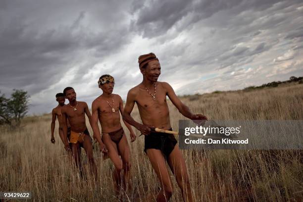 Group of San Bushmen from the Khomani San community practice their hunter-gatherer craft in the Southern Kalahari desert on October 15, 2009 in the...