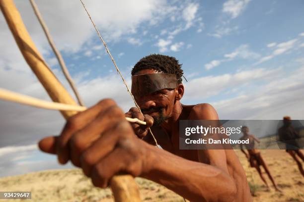 Bushman from the Khomani San community strikes a traditional pose in the Southern Kalahari desert on October 15, 2009 in the Kalahari, South Africa....