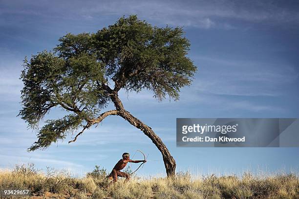 Bushman from the Khomani San community strikes a traditional pose in the Southern Kalahari desert on October 16, 2009 in the Kalahari, South Africa....