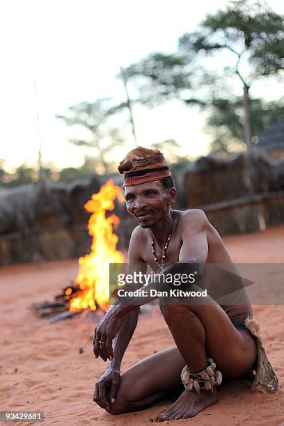 San Bushmen from the Khomani San community sits by a fire in the Southern Kalahari desert on October 16, 2009 in the Kalahari, South Africa. One of...