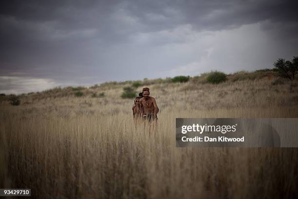 Group of San Bushmen from the Khomani San community practice their hunter-gatherer craft in the Southern Kalahari desert on October 15, 2009 in the...