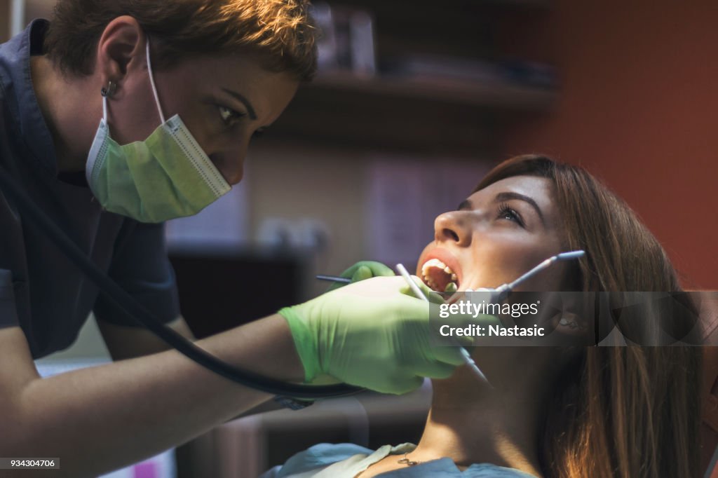 Blond young woman having dental exam