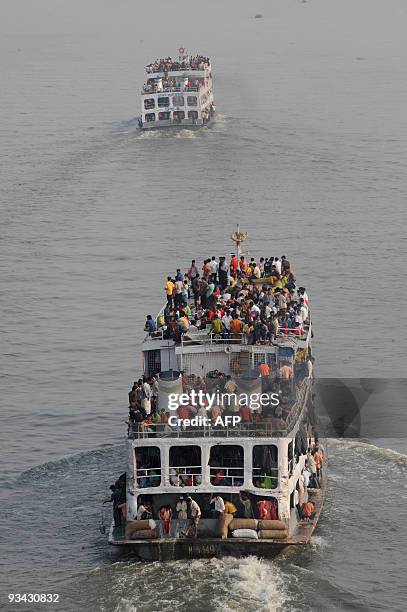 Thousands of Bangladeshis cram ferries in Dhaka on November 26, 2009 as they rush home to be with their families in remote villages before the Muslim...