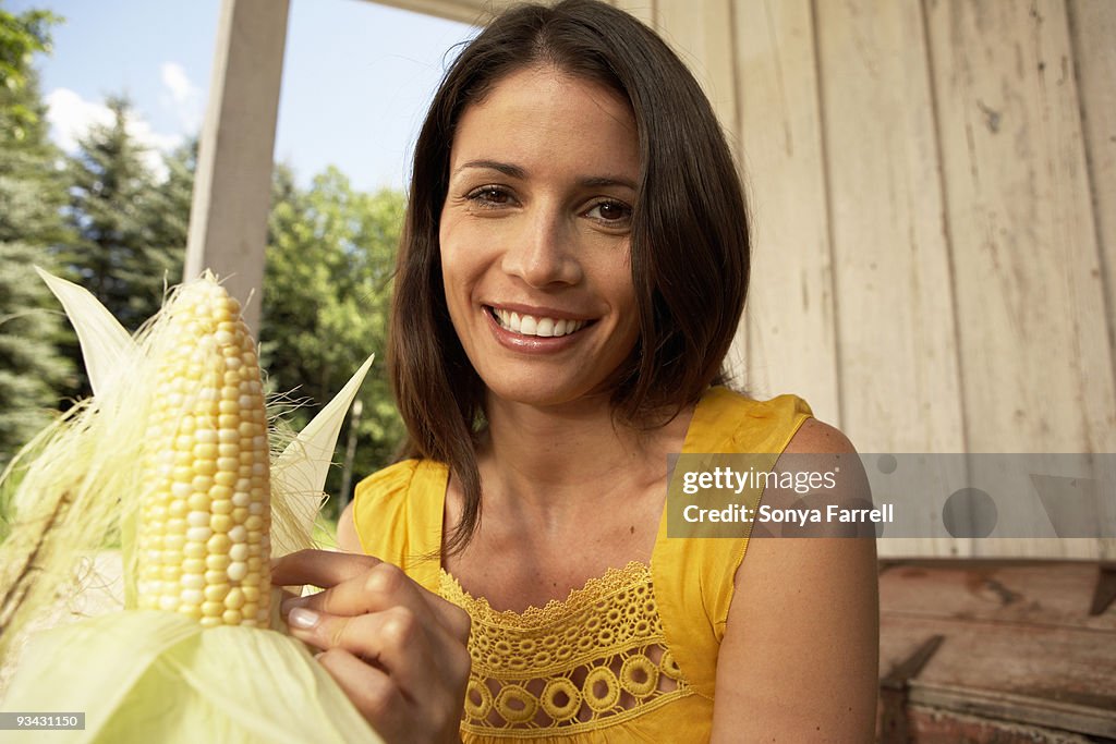 Woman shucking corn