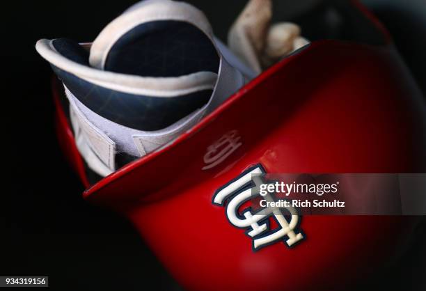 St. Louis Cardinals' batting helmet and shin guards in the dugout before a spring training game against the Houston Astros at FITTEAM Ball Park of...