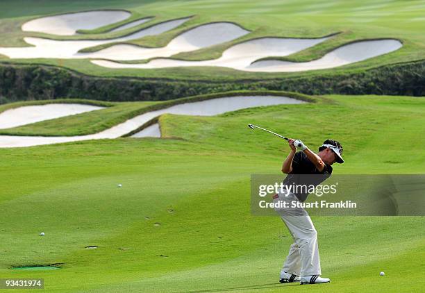 Charlie Wi of Korea plays his approach shot on the 15th hole during Fourball on the first day of the Omega Mission Hills World Cup on the Olazabal...