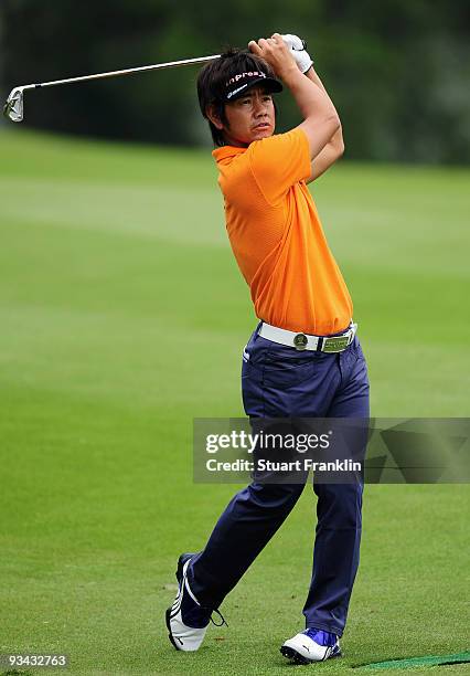 Hiroyuki Fujita of Japan plays his approach shot on the 16th hole during Fourball on the first day of the Omega Mission Hills World Cup on the...