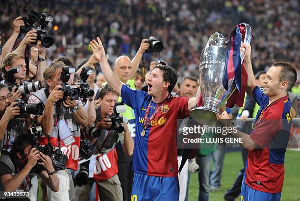 Barcelona´s Argentinian forward Lionel Messi and Barcelona´s midfielder Andres Iniesta celebrate with the Champions League Cup afte the trophy...