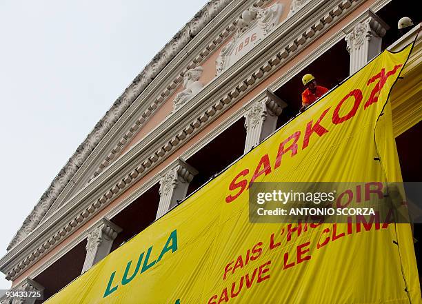 Greenpeace activists display a banner on the facade of Amazon teather, November 26, 2009 in Manaus, demanding Presidents of the US, Brazil and France...