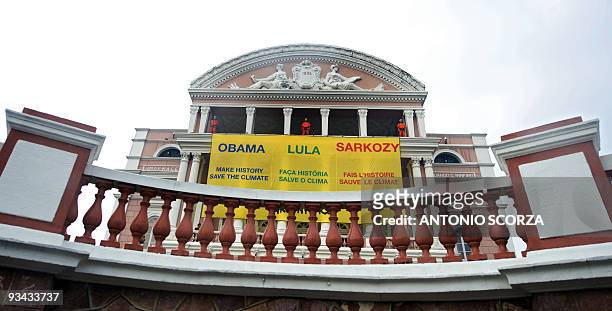 Greenpeace activists display a banner on the facade of Amazon teather, November 26, 2009 in Manaus, demanding Presidents of the US, Brazil and France...