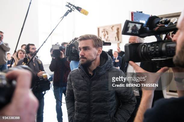 Borussia Dortmund's defender Marcel Schmelzer arrives for a hearing as a witness in the trial on a bomb attack on the team bus of German first...