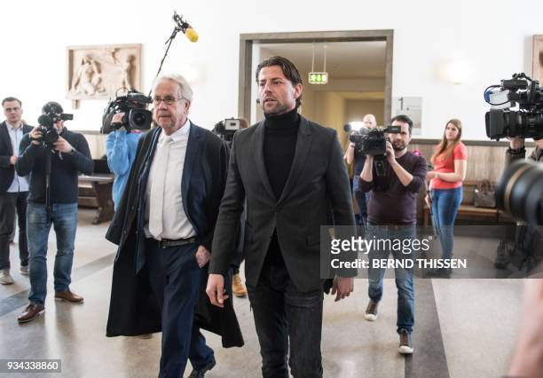 Borussia Dortmund's goalkeeper Roman Weidenfeller together with lawyer Alfons Becker arrives for a hearing as a witness in the trial on a bomb attack...