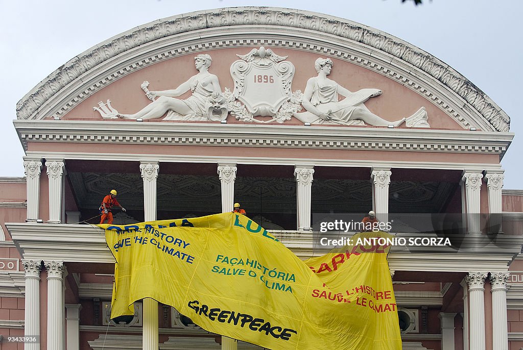 Greenpeace activists display a banner on