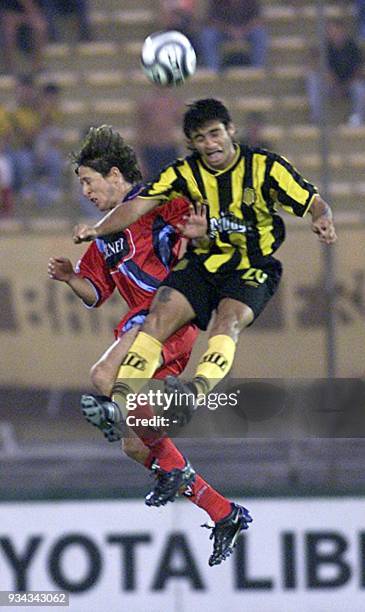 Carlos Bueno , of Penarol, fights for the ball against Dannes Coronel, of Nacional de Quito, 12 March 2002 in the Centenario de Montevideo stadium...