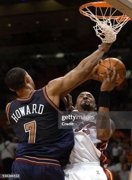 Denver Nuggets forward Juwan Howard fouls Miami Heat center Alonzo Mourning in the first half 16 March 2002 at the American Airlines Arena in Miami,...