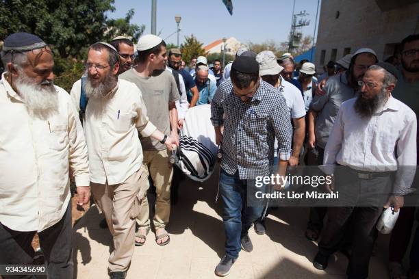 Family members and friends carry the body of Israeli Adiel Coleman during his funeral on March 19, 2018 in Kochav Hashahar settlement, West Bank....