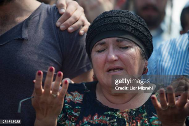 Yael, mother of Israeli Adiel Coleman, mourns over his grave during his funeral on March 19, 2018 in Kochav Hashahar settlement, West Bank. Hundreds...