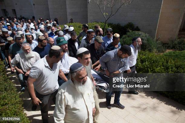 Family members and friends carry the body of Israeli Adiel Coleman during his funeral on March 19, 2018 in Kochav Hashahar settlement, West Bank....