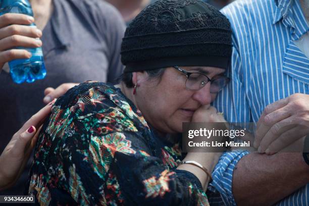 Yael, mother of Israeli Adiel Coleman, mourns over his grave during his funeral on March 19, 2018 in Kochav Hashahar settlement, West Bank. Hundreds...