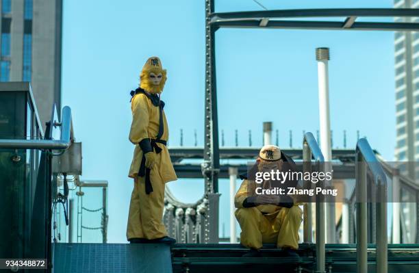 Young people wearing costume of Sun WuKong, wait on bridge to attract few tourists. In 2017, Tianjin's gross domestic product was 1859.5 billion...